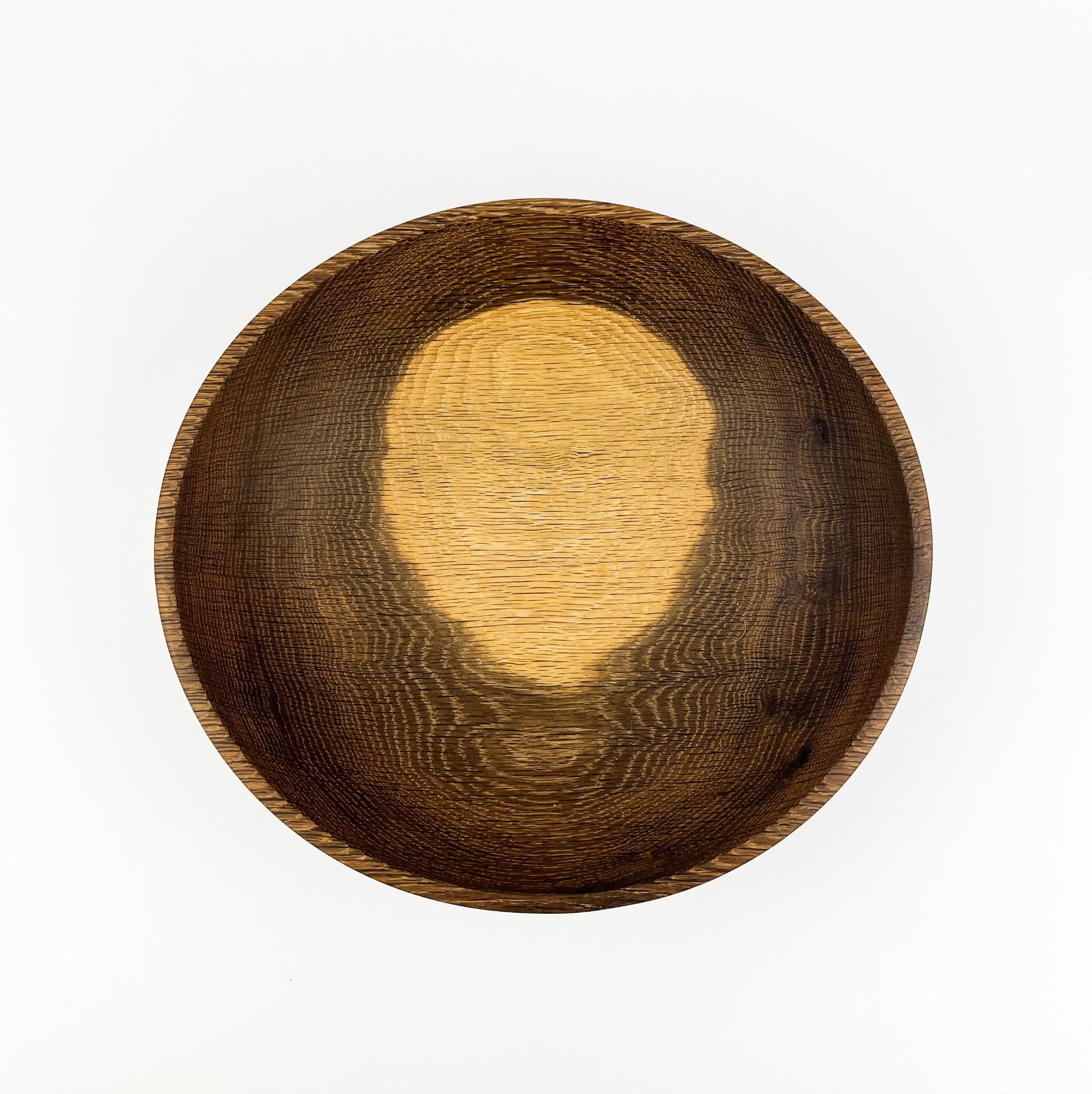 Wooden bowl with a textured surface on a white background