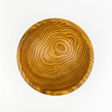 Wooden bowl with visible grain pattern on a white background