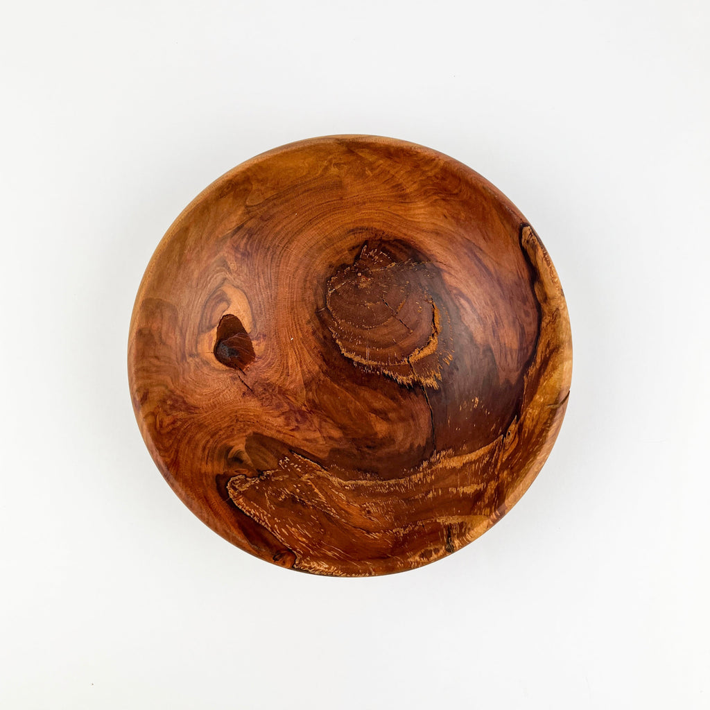 Wooden bowl with natural grain and texture on a white background