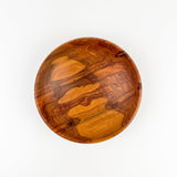 Wooden bowl with a natural pattern on a white background