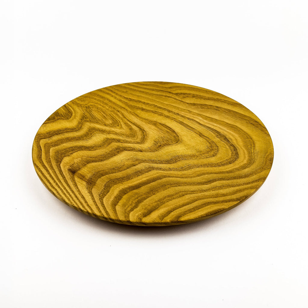 Wooden round tray with wavy grain pattern on a white background