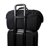 Black rolling suitcase with a black duffel bag on top
