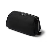 Black toiletry bag with a visible brand logo on a white background