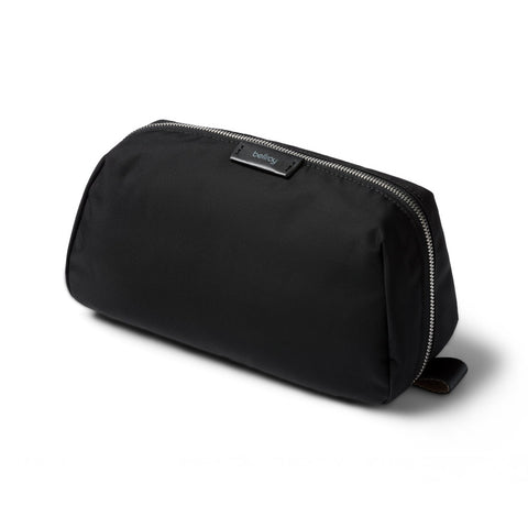 Black toiletry bag with a visible brand logo on a white background