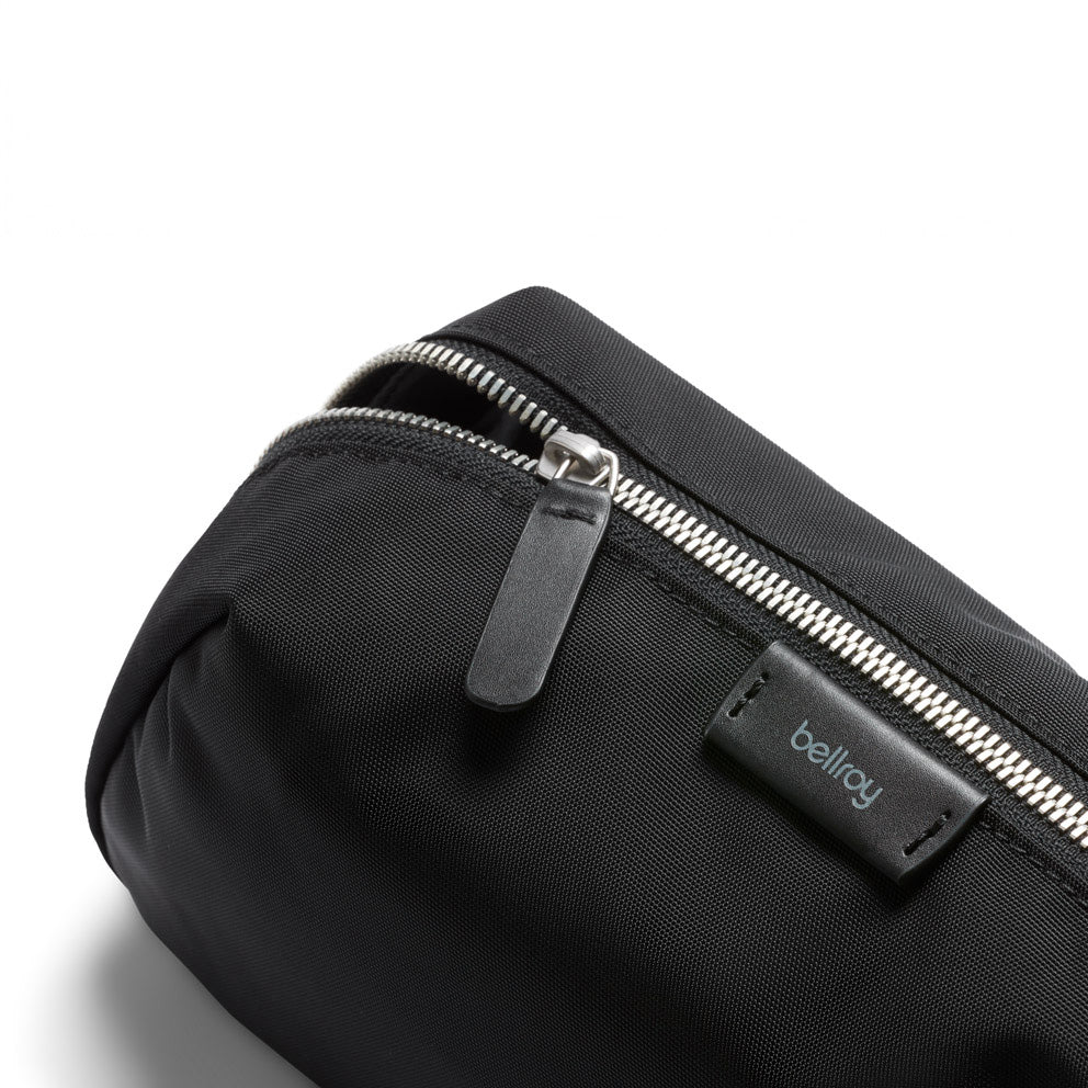 Black bag with a zipper and 'bellroy' logo on a white background