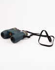 Pair of binoculars with a strap on a white background