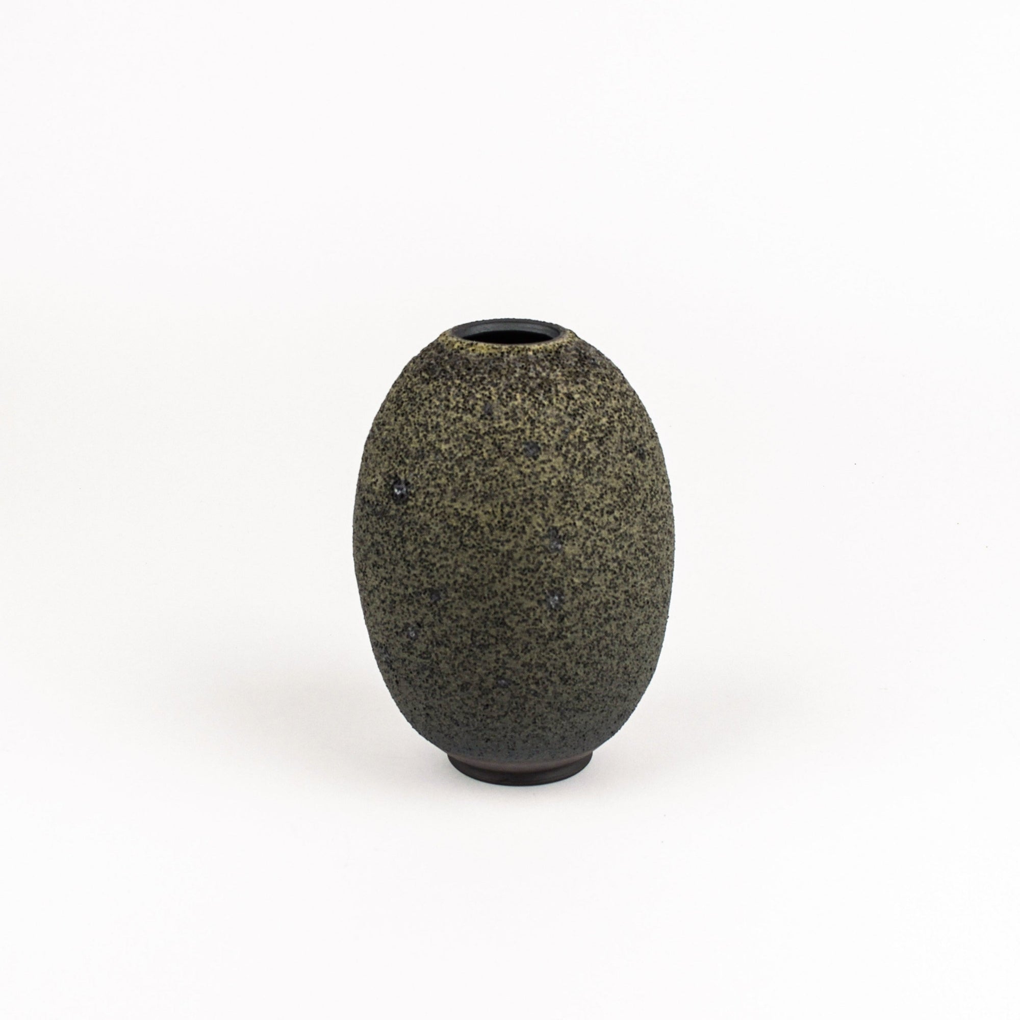 A small, rounded ceramic vase with a textured, speckled dark gray and black glaze, standing on a white background.