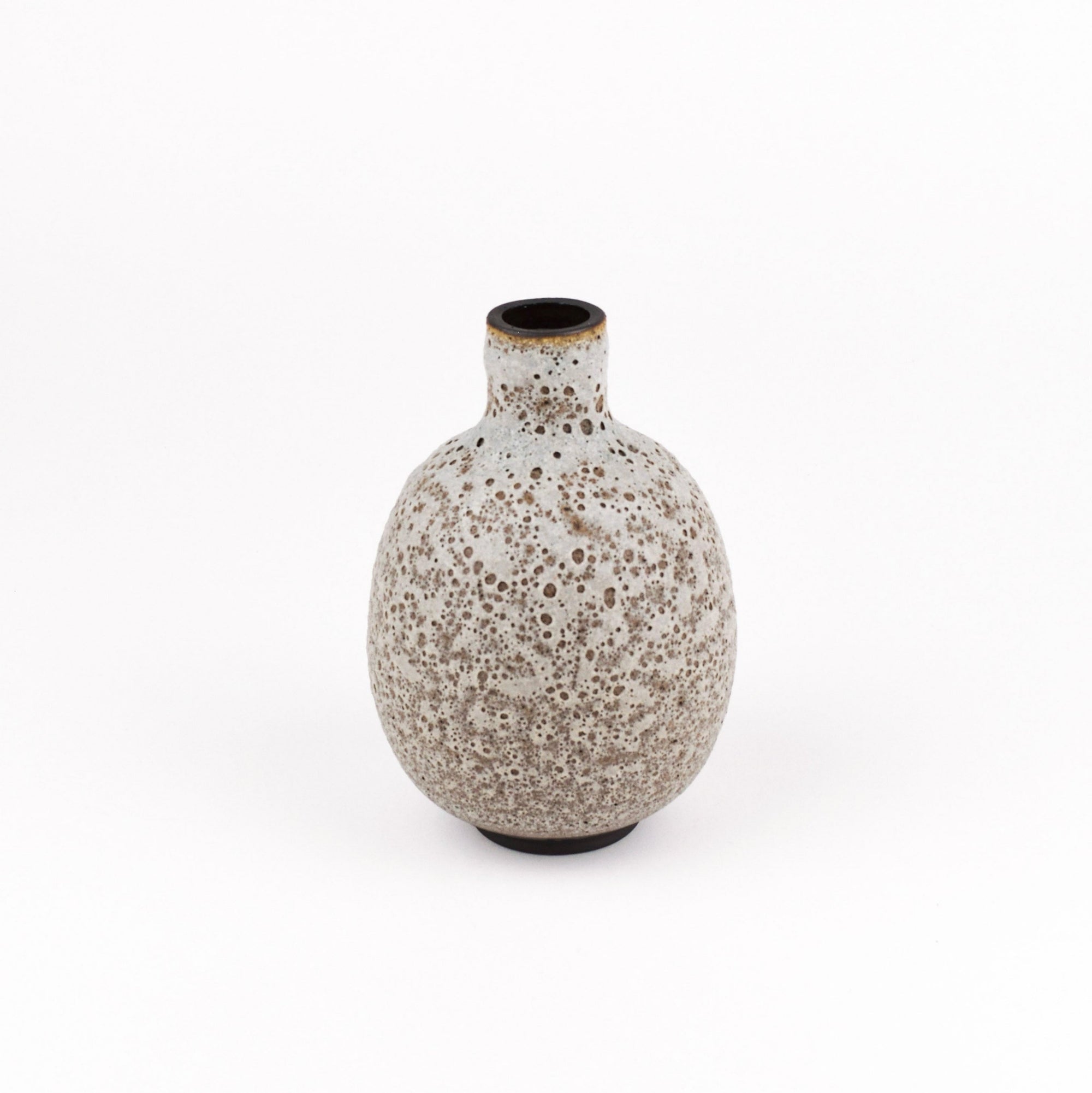 A small ceramic vase with a rounded bulbous body and a short neck, featuring a speckled beige and brown glaze on a white background.