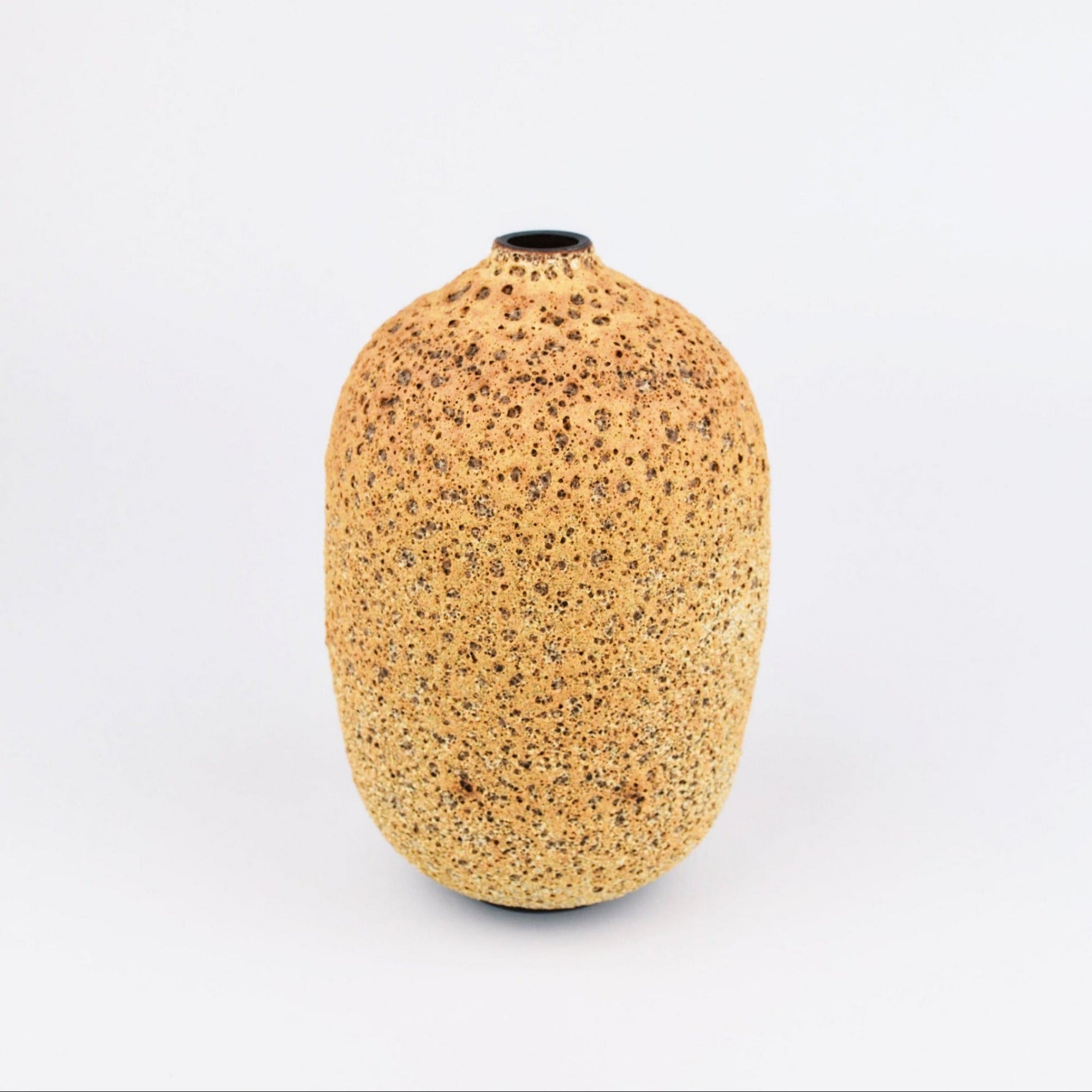 A small, rounded ceramic vase with a textured, speckled golden-brown glaze and a short, narrow neck, photographed against a seamless white background.