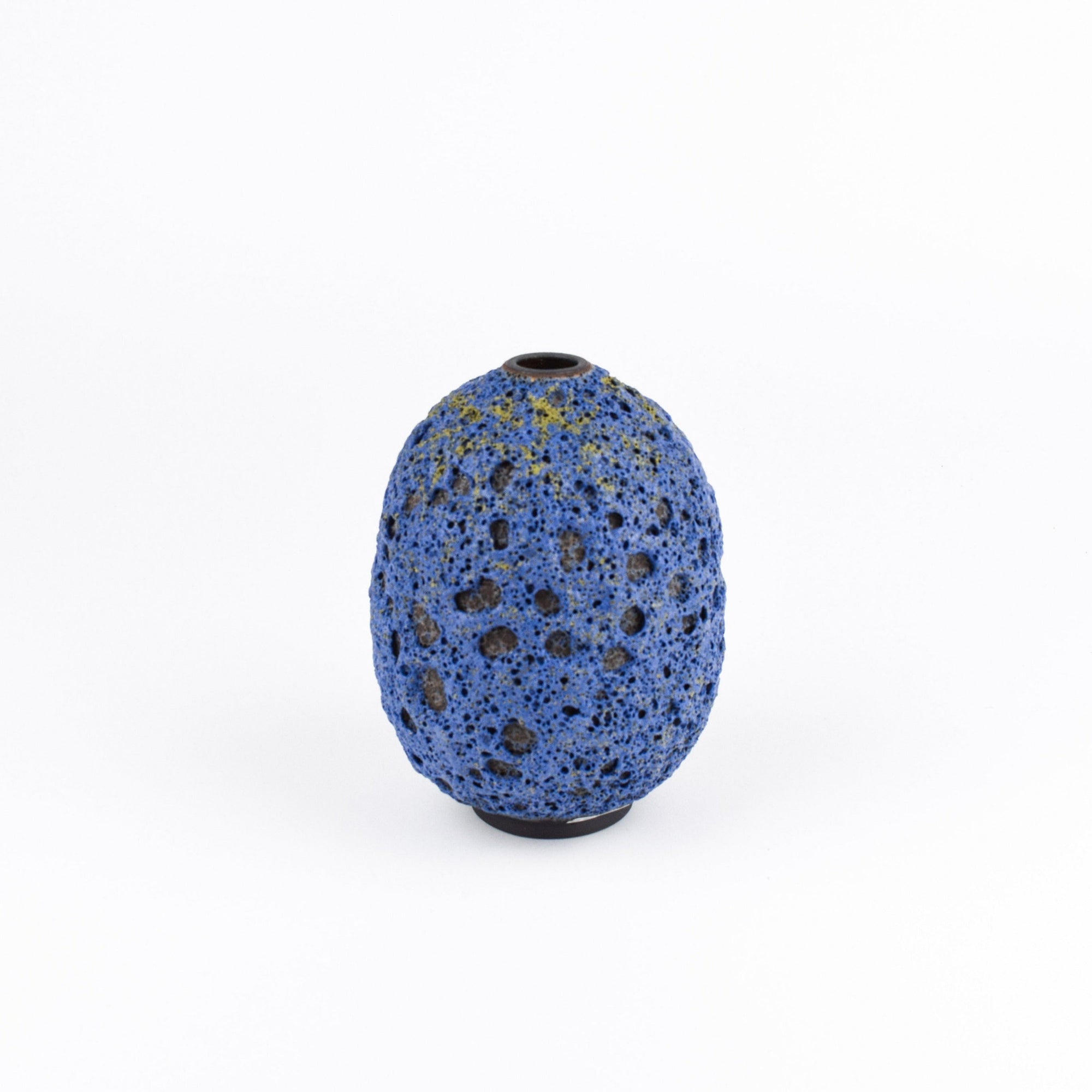 A small, rounded ceramic vase with a textured blue and black speckled pattern, centered on a clean white background.