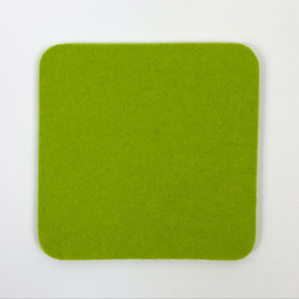 Solid green square coaster on a white background