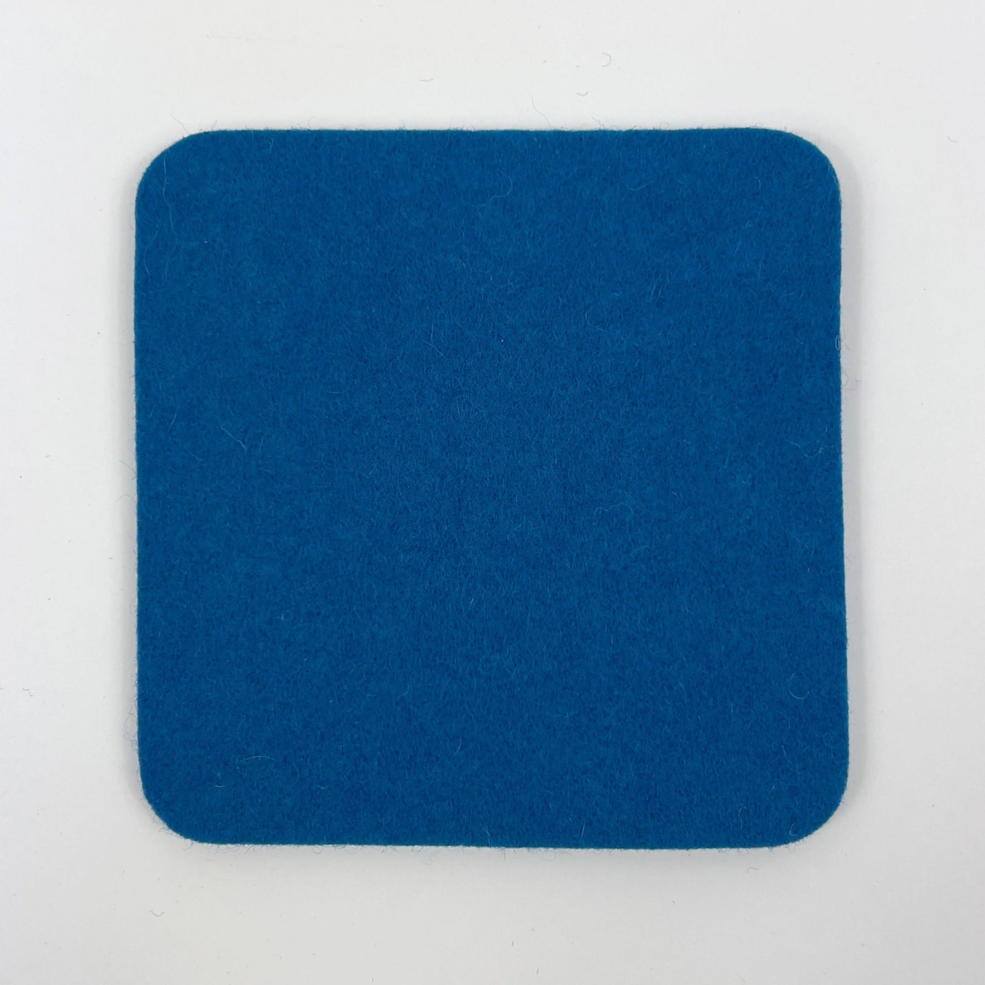 Blue square coaster on a light gray background
