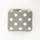 Gray wallet with white polka dots on a white background