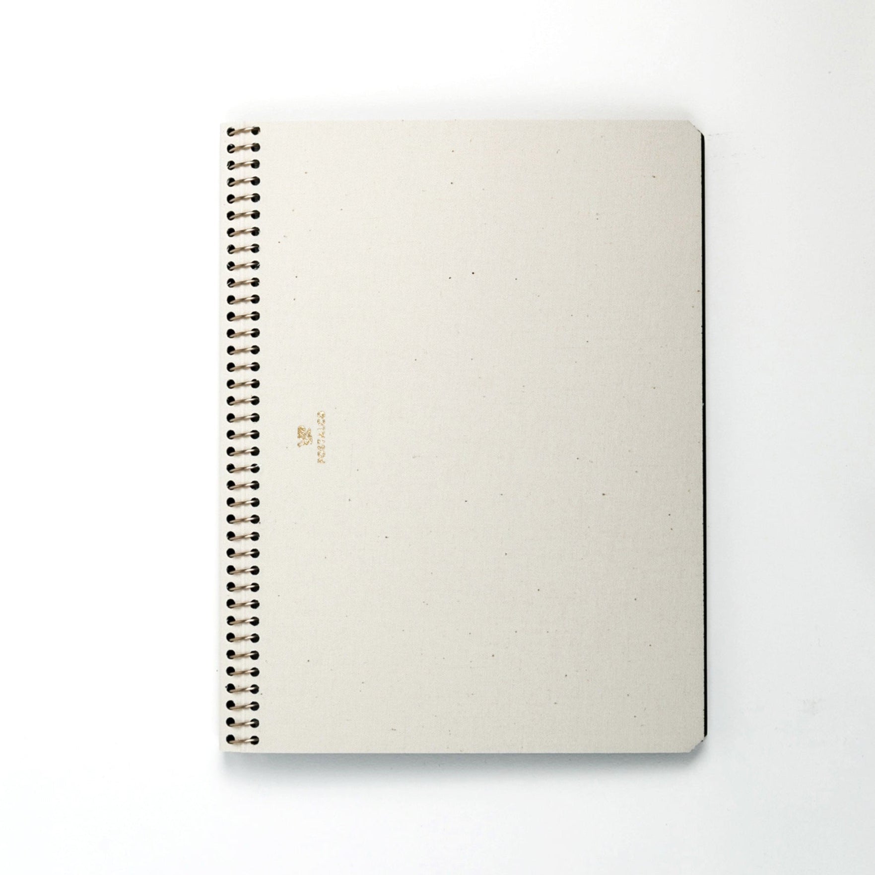 Beige spiral-bound notebook on a white background