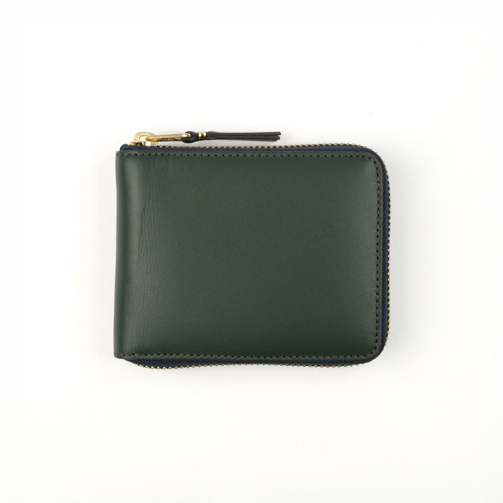 Green wallet with a gold zipper on a white background