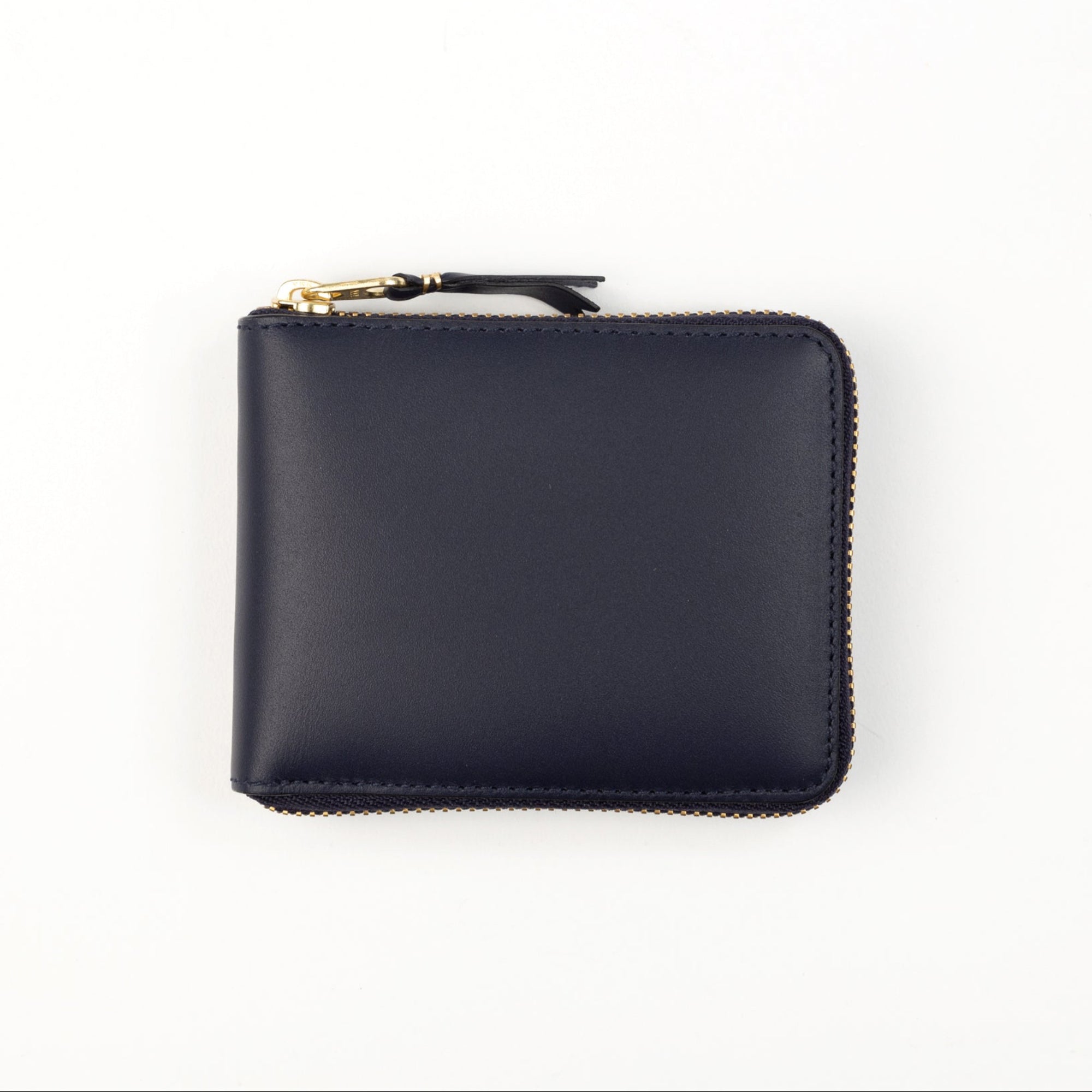 A navy blue leather wallet with a zipper closure and gold-toned metal hardware.