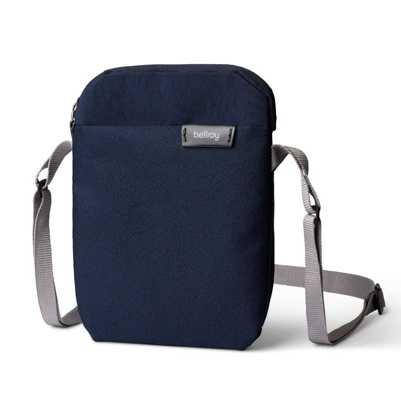 Navy blue crossbody bag with gray strap on a white background