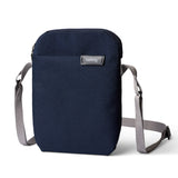 Navy blue crossbody bag with gray strap on a white background