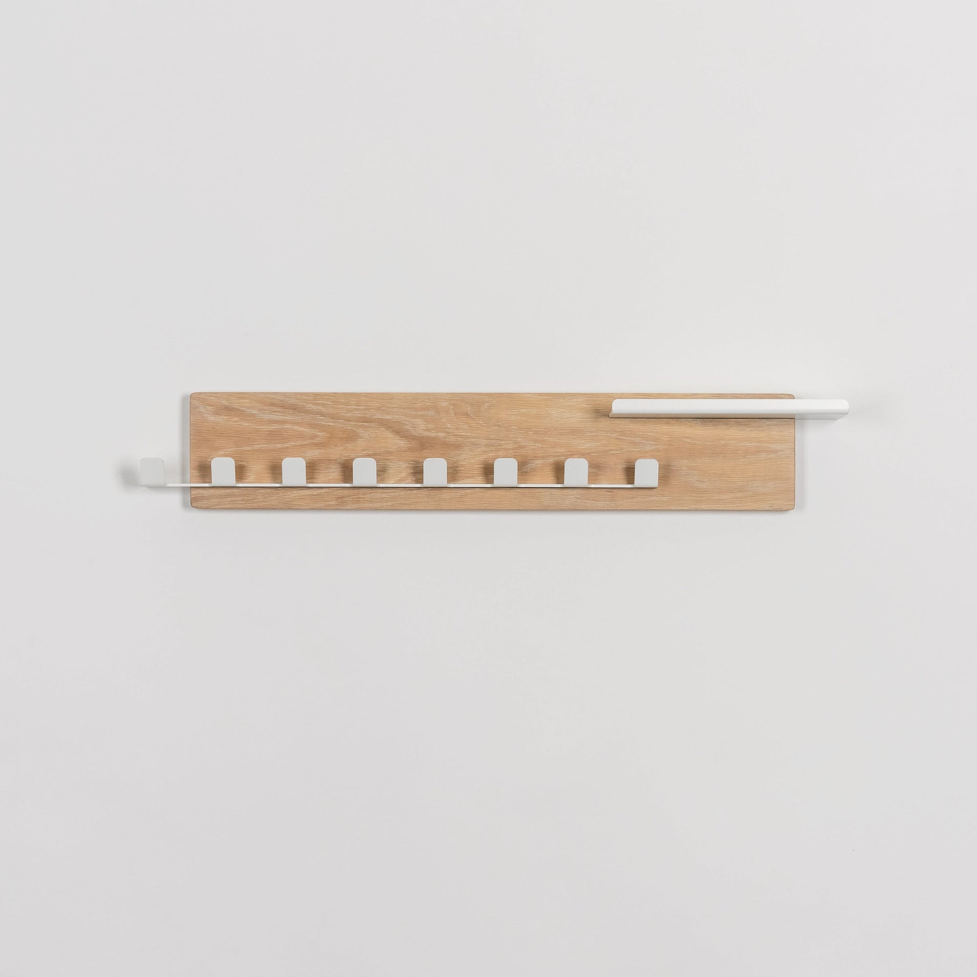 Wooden wall shelf with white accents on a light gray background
