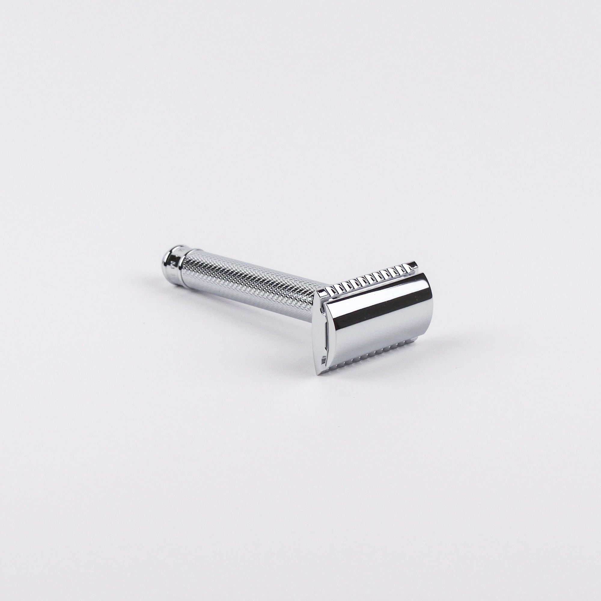 Chrome safety razor on a white background