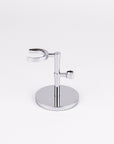 Chrome razor and shaving brush holder on a white background