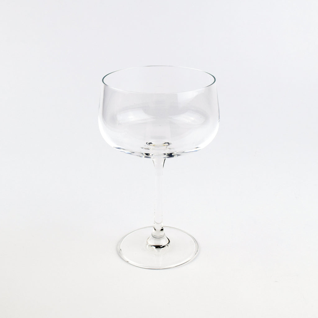 Clear glass cocktail glass on a white background