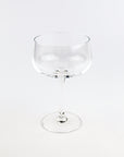 Clear glass cocktail glass on a white background