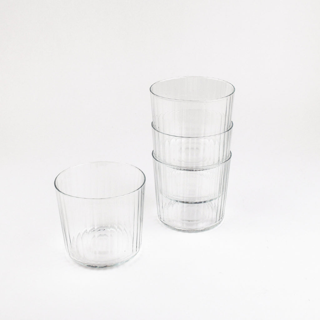 Set of clear glass tumblers on a white background