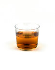 Glass of amber liquid on a white background