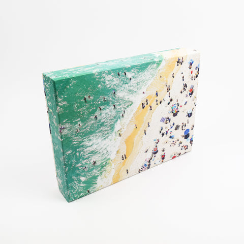 Photo puzzle box of a beach scene with people on a white background