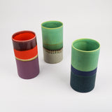 Three colorful ceramic vases on a white background