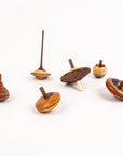 Set of wooden spinning tops on a white background