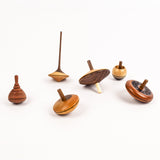 Set of wooden spinning tops on a white background