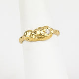 Gold ring with a diamond on a white background