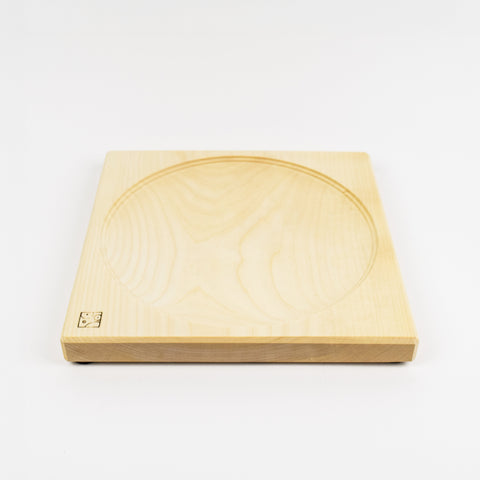 Wooden square top spinning plate with circular groove on a white background