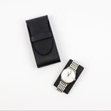 Black watch case with a silver watch on a white background