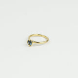 Gold ring with a gemstone on a light gray background