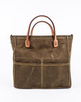 Brown waxed canvas tote bag with tan leather handles on a white background