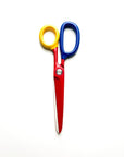 Colorful pair of scissors with red blades, yellow left handle, and blue right handle on a white background.