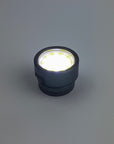 Black LED light bulb on a gray background