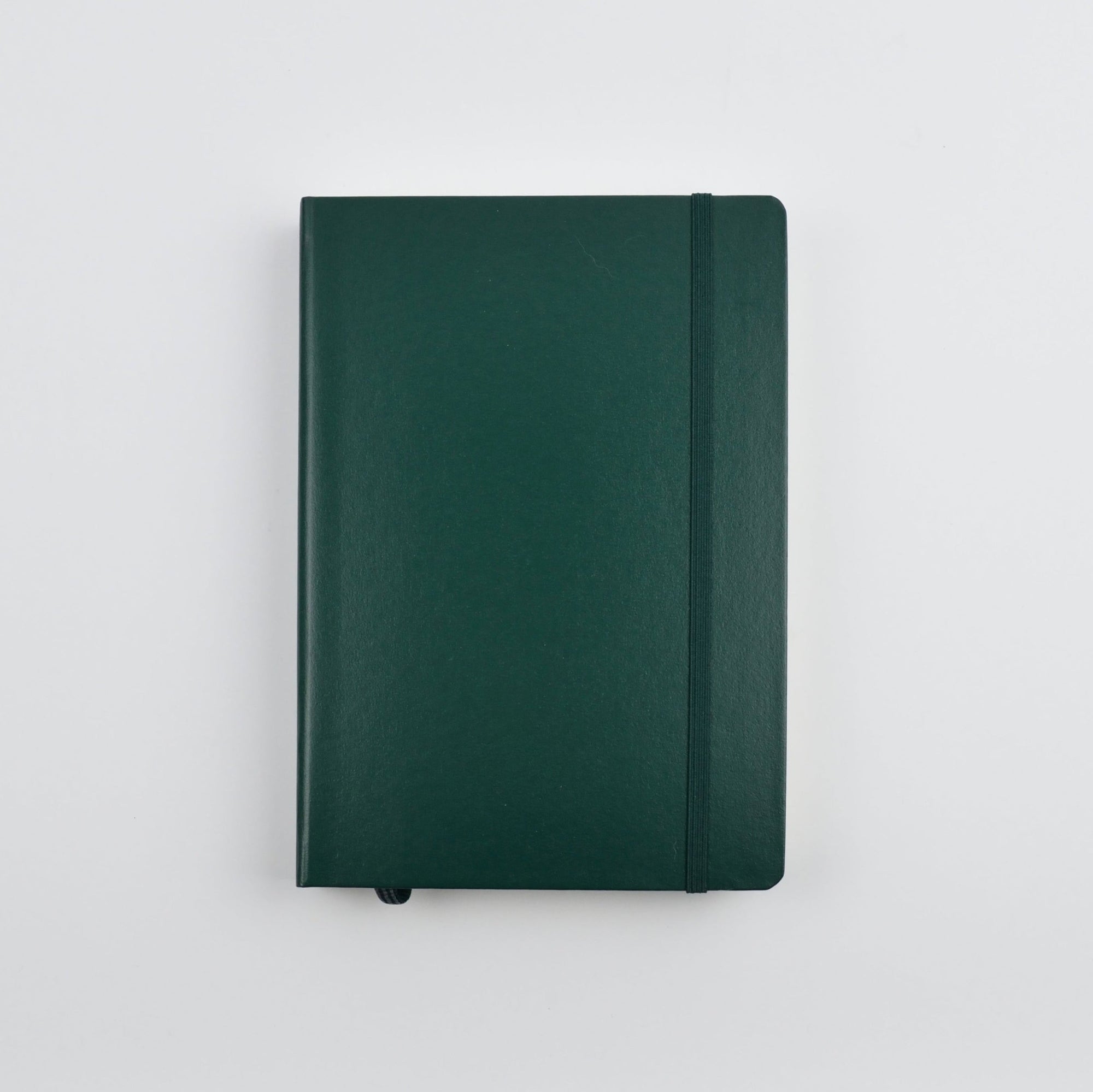 Green notebook on a white surface