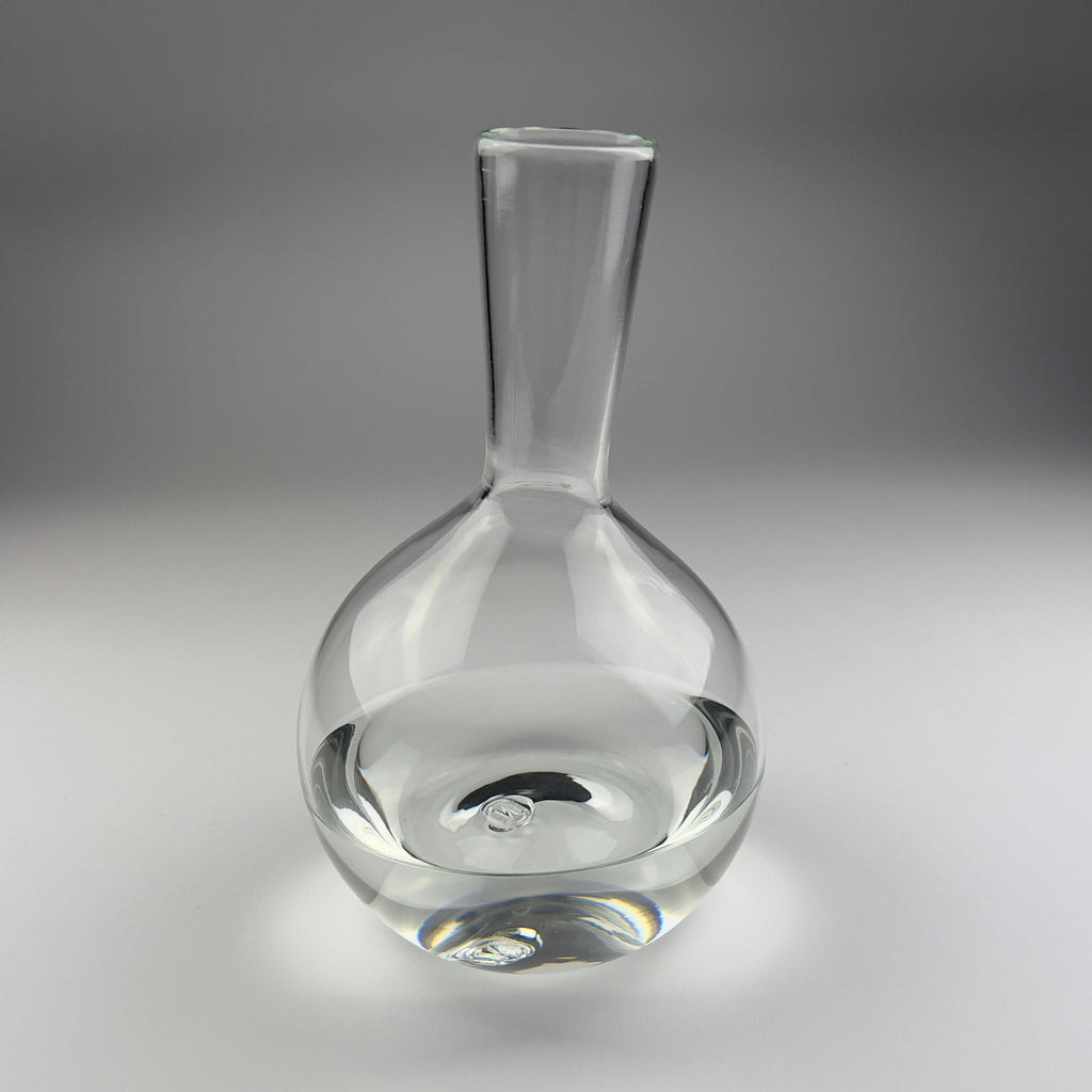 Clear glass decanter on a gray background