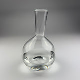 Clear glass decanter on a gray background