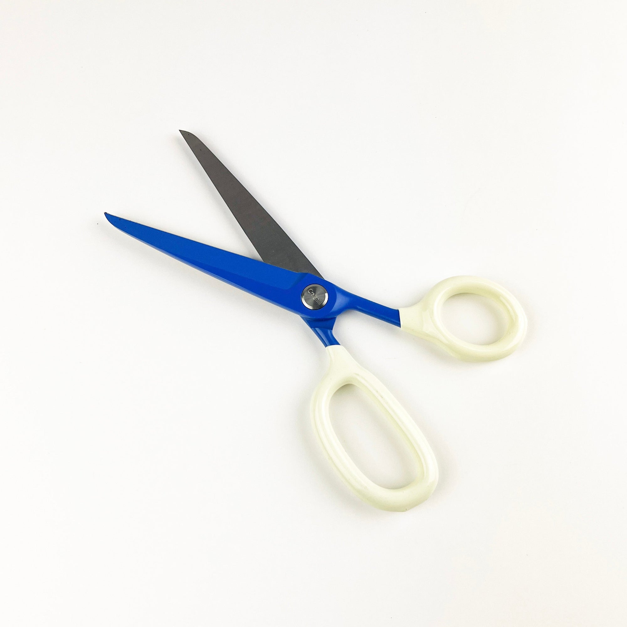 Scissors with blue blades and white handles on a white background
