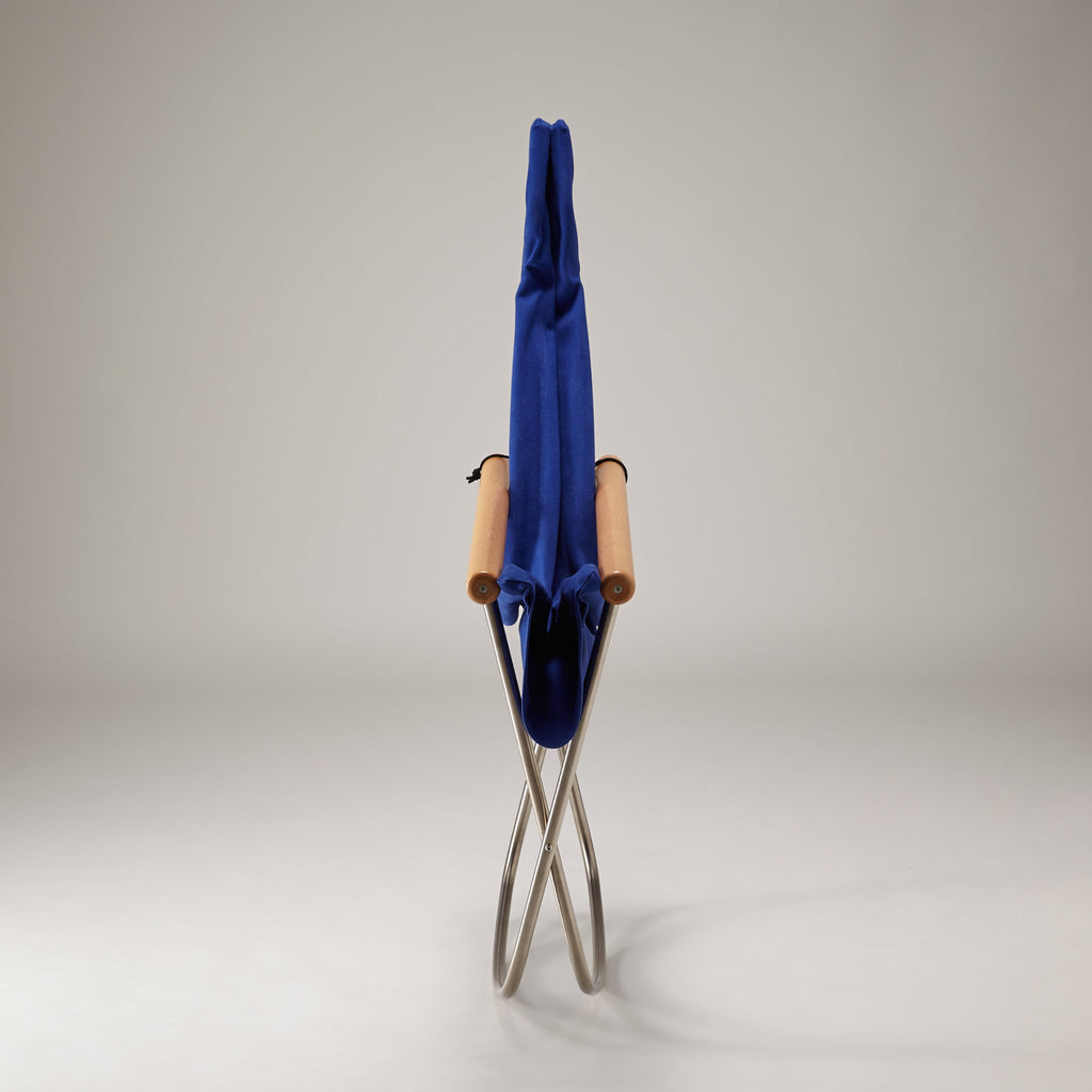 Folding chair with a blue cover on a gray background