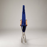 Folding chair with a blue cover on a gray background