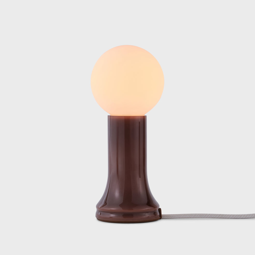 Small table lamp with a round bulb on a white background