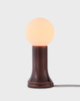 Small table lamp with a round bulb on a white background
