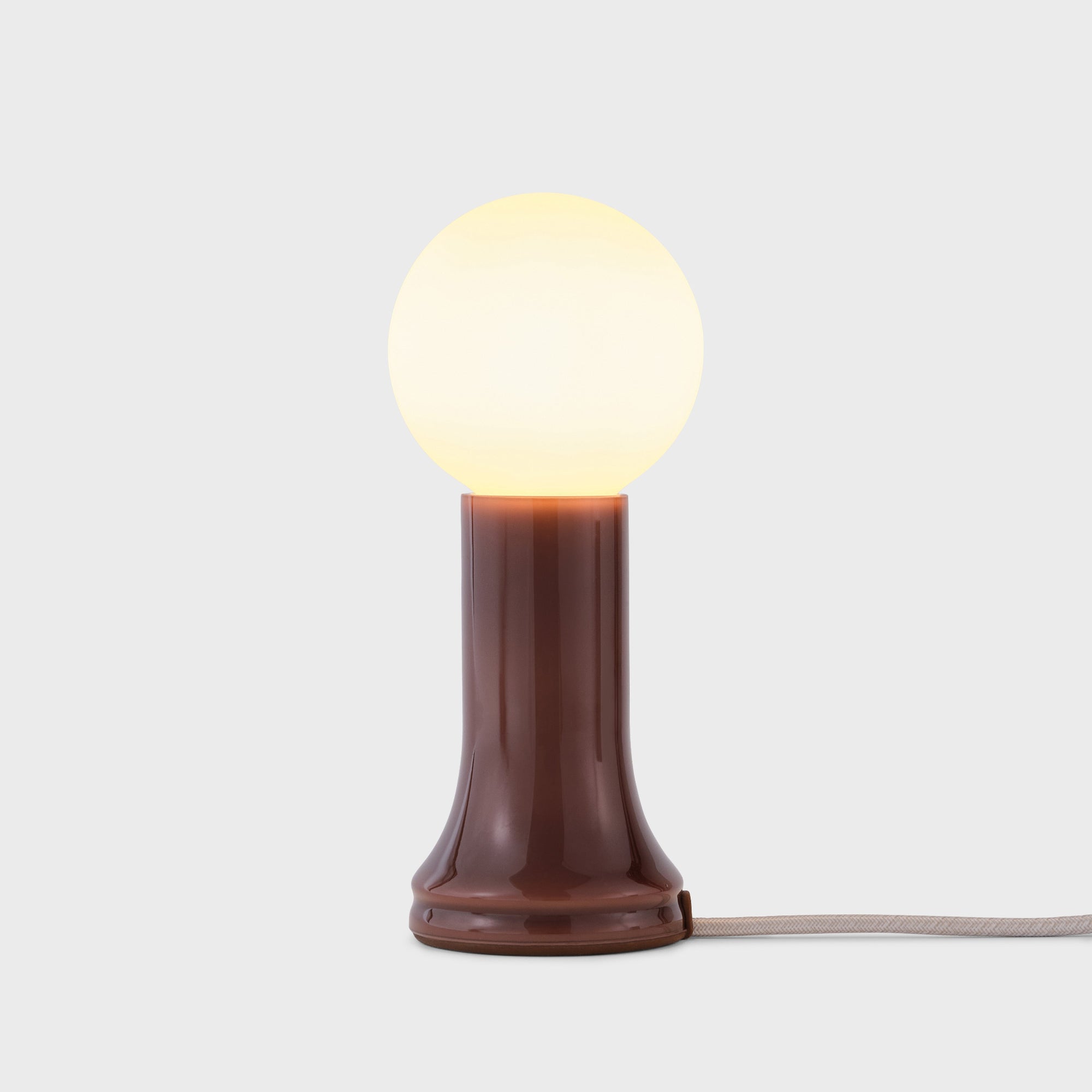 Table lamp with a brown base and white bulb on a light gray background
