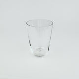 Clear glass tumbler on a light gray background